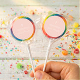 Personalised lollipops with cross print, rainbow-striped wrapper and clear stick