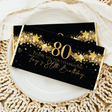 Black chocolate bar wrapper with gold 80, stars, and Thank you for celebrating text