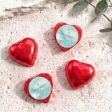 Red foil heart chocolates with blue center label and gold cross