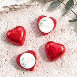 Red foil heart chocolates with baptism cross and floral label on white center