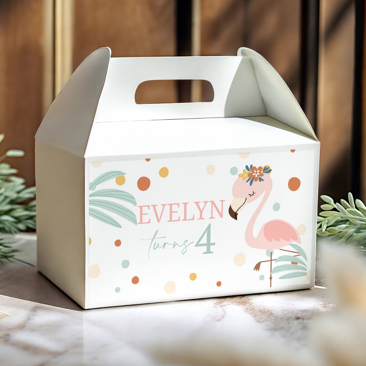 White flamingo gable box with handle cutout, 'Evelyn turns 4'.