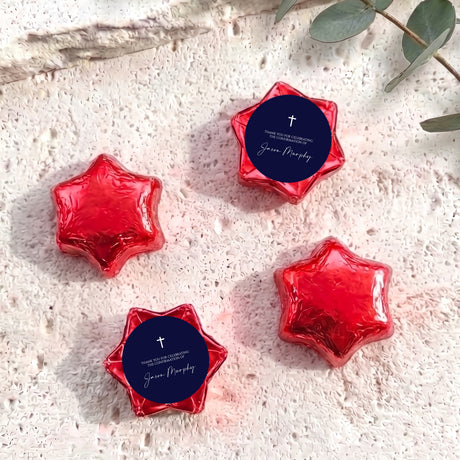Red foil star chocolates with dark blue round label featuring cross and message