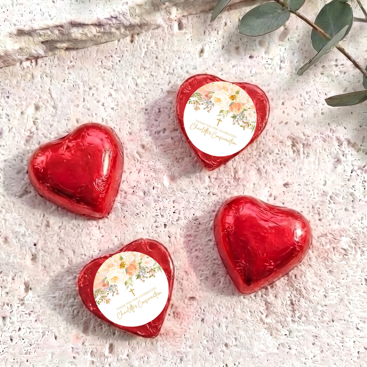 Red foil-covered chocolate hearts with floral personalized insert and golden cross