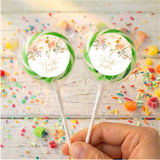 Personalised christening lollipops with green wrapped candy and floral name labels