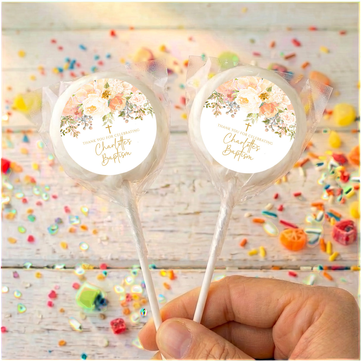 Personalised christening lollipops with white wrapped candy and floral name labels