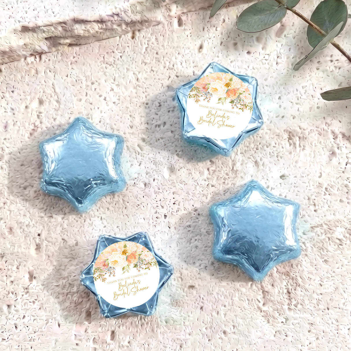 Blue foil-covered chocolate stars with one floral personalized label