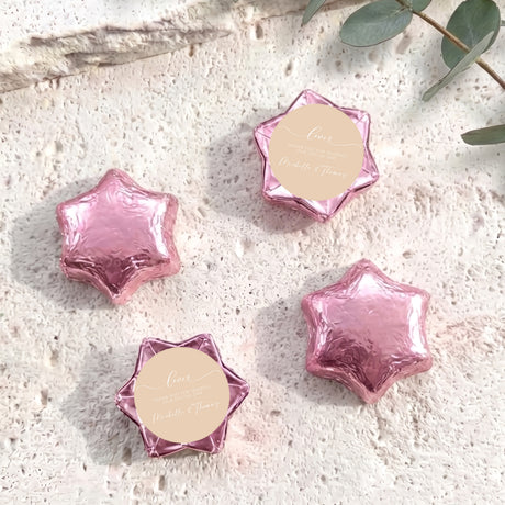 Pink foil-covered chocolate stars with round name tag toppers