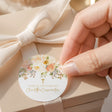 Round confirmation labels with peach floral wreath and small cross, thank-you text