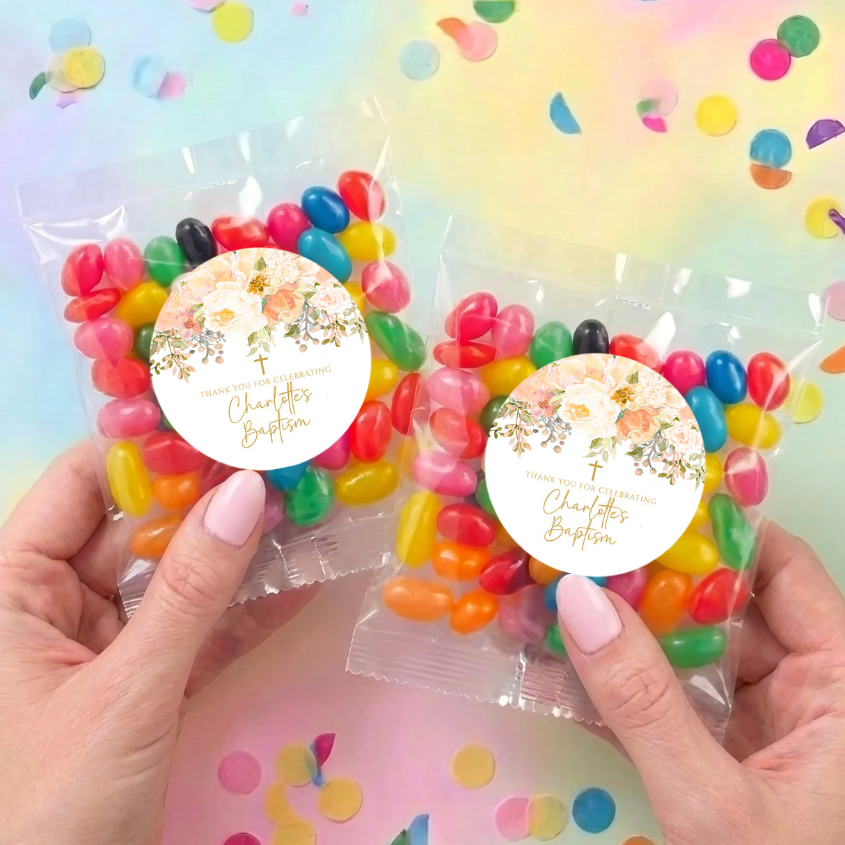 Two personalized jelly bean bags, each with round floral label, held in hands