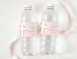 Personalised water bottle labels on clear plastic bottles with pink floral accents