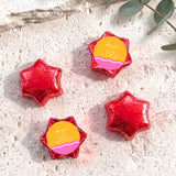 Baby shower foil-covered chocolate stars with red star-shaped foil wrappers