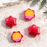 Personalised foil-covered chocolate stars in red with printed name label