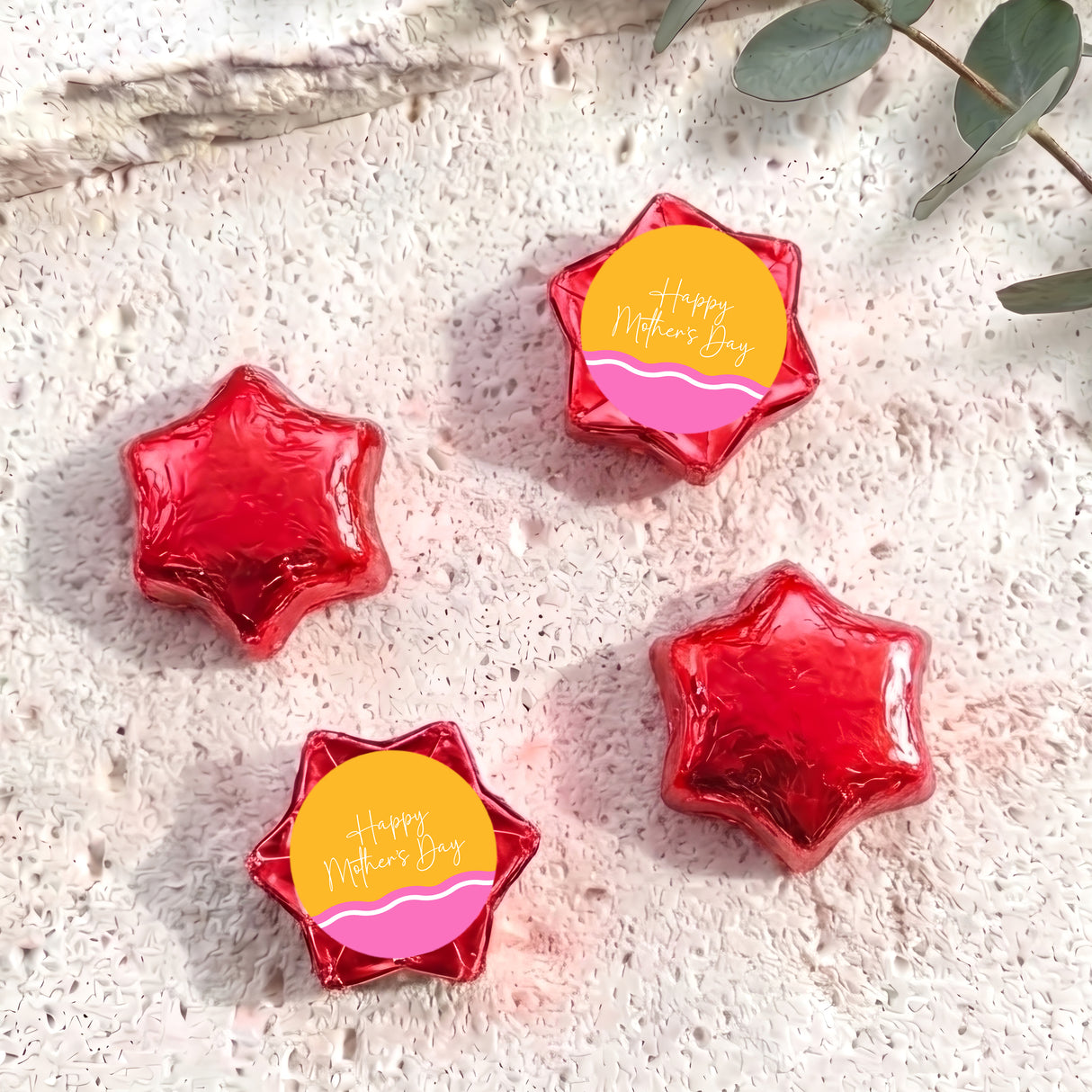 Red foil star chocolates with “Happy Mother’s Day” label, arranged in set.