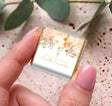 Floral confirmation mini chocolate box with gold cross; pastel peach design in hand