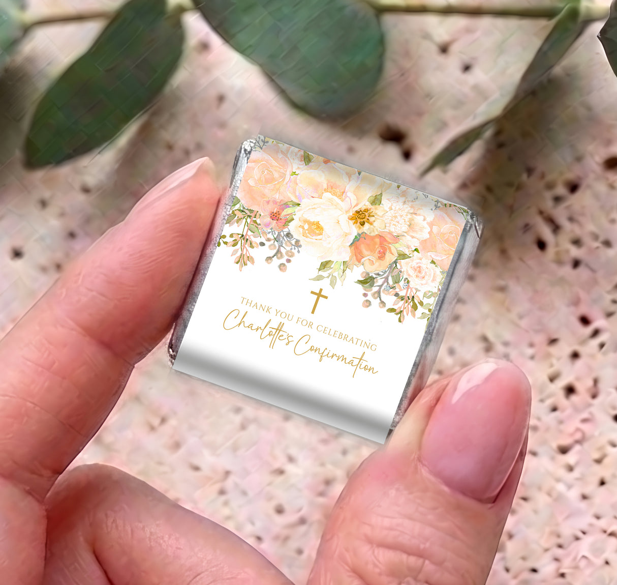 Floral confirmation mini chocolate box with gold cross; pastel peach design held