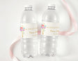 Personalised water bottle labels on clear plastic bottles with floral cross and name