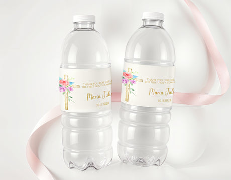 Personalised water bottle labels on clear plastic bottles with floral cross and name