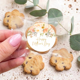 Mother's Day bite-size cookie with floral print, held in hand