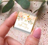 Handheld mini chocolate box with floral 'Happy Mother's Day' label on silver wrapper