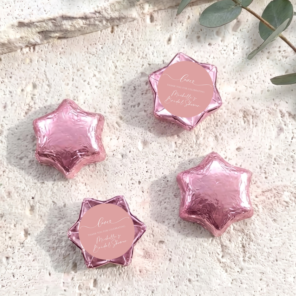Set of dusty pink foil-covered chocolate stars with a pink heart label