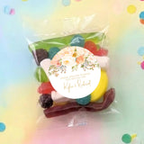 Clear lolly bag of mixed candies with a round floral personalised thank-you label