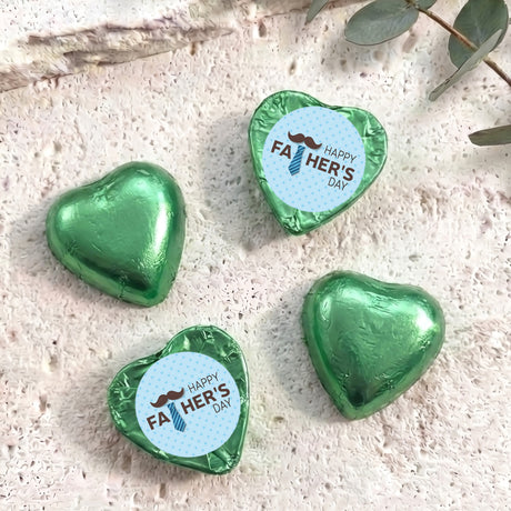 Foil-covered chocolate hearts with “Happy FA HER’S DAY” labels, green heart shapes