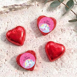 Red foil chocolate hearts with unicorn “Zara’s 6th Birthday” label.
