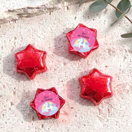 Red star-shaped foil chocolate with “Zara’s 6th Birthday” unicorn rainbow label