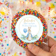 Clear bag of rainbow sprinkles with round baby shower label and rabbit illustration