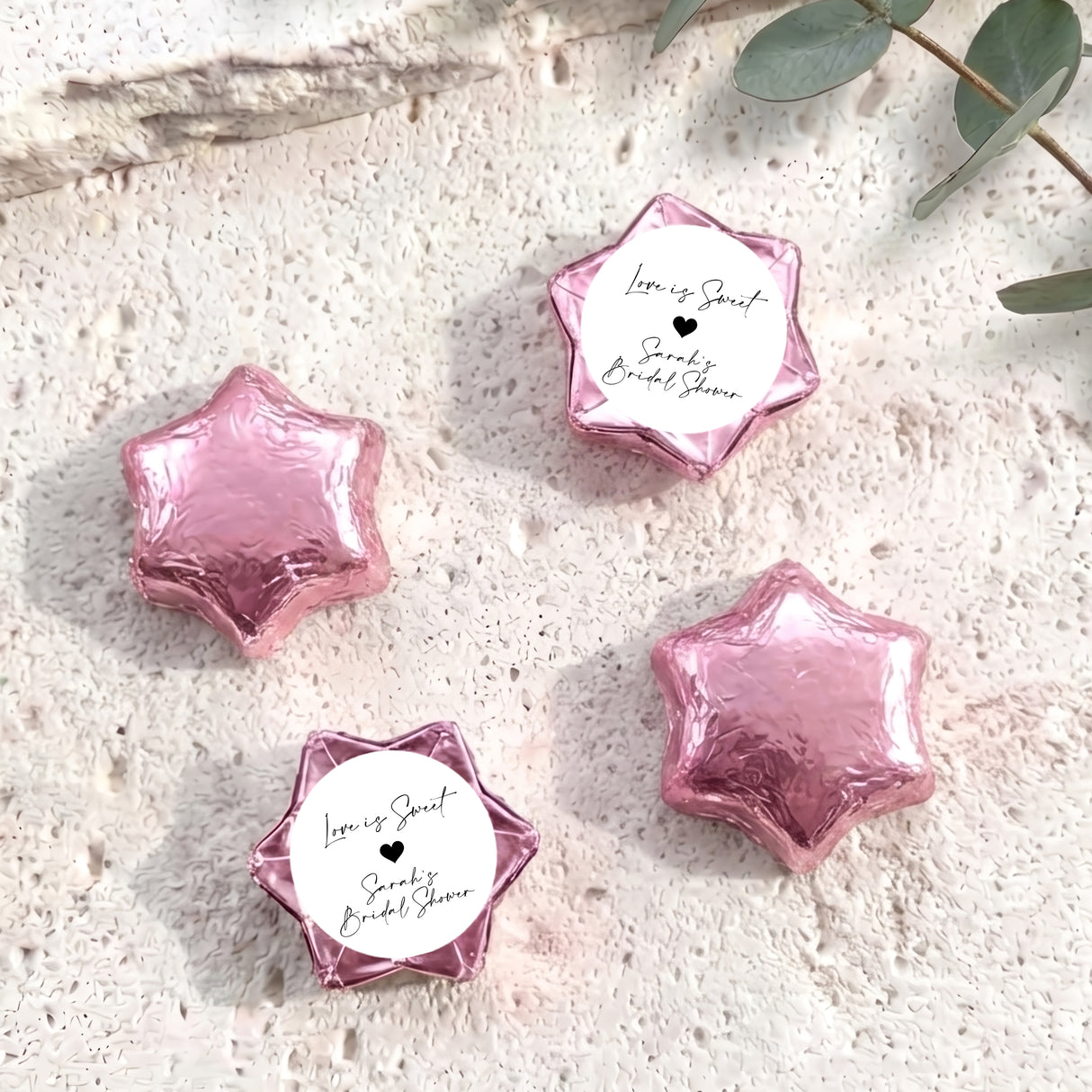 Pink foil chocolate stars with round bridal shower label and black heart design