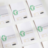 White first communion chocolate wrappers with green cross and leaf border, multiple packs