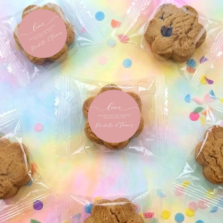 Personalised choc chip cookies in clear bags with pink round thank-you label, assorted.