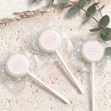 Mini lollipops with yellow lollipop tops, wrapped in clear plastic on white sticks.