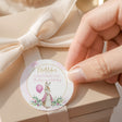 Round pink christening label with rabbit, cross, and thanks-for-celebrating text