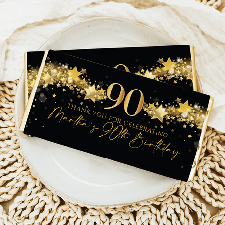 90th birthday chocolate bar wrapper, black with gold stars and “90” thank you text