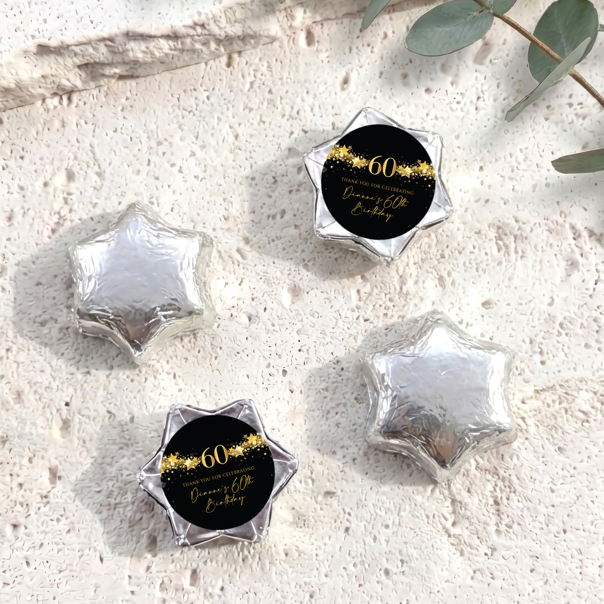 60th birthday star chocolates with silver foil-covered stars and black-and-gold 60 label