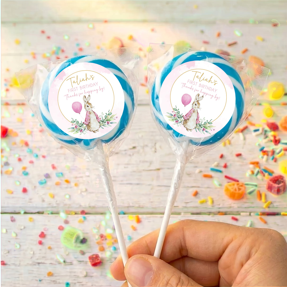 Blue round lollipops with Peter Rabbit first-birthday label for Talayah on sticks