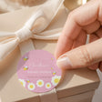 Pink round baby shower label with bee flowers and 'Thanks for buzzing by' wording