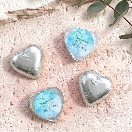Foil-covered chocolate hearts in silver with a printed birthday message.