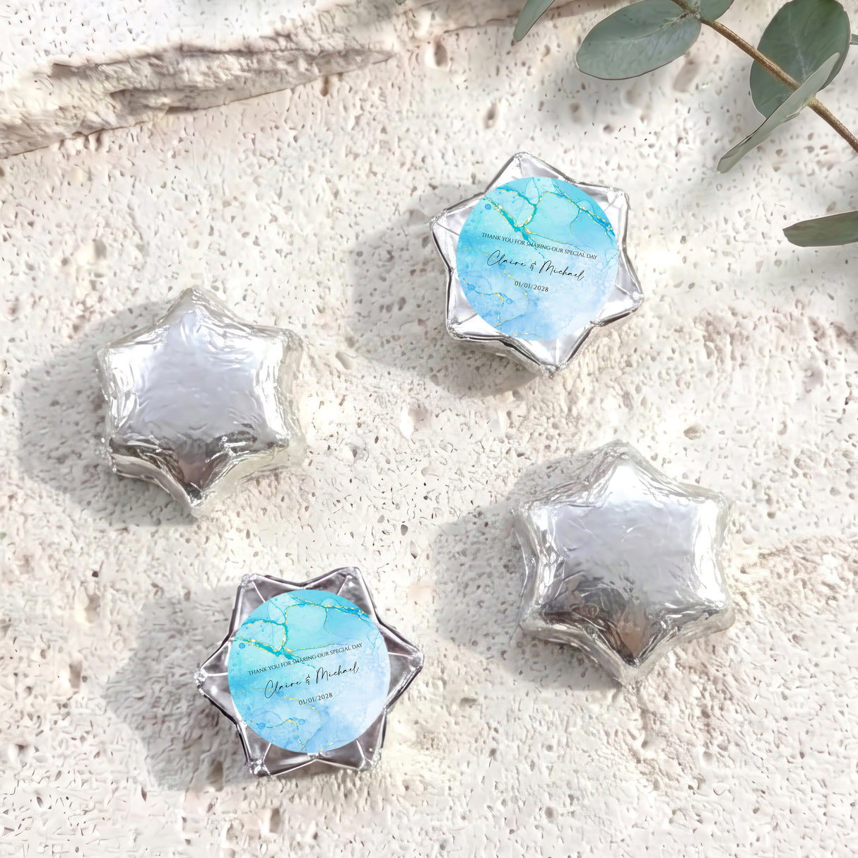 Silver foil-wrapped chocolate stars, six-point shapes with blue center label.