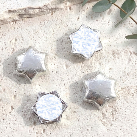 Personalized foil-covered chocolate stars in silver/white, with round label center.