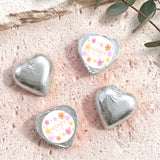 Silver foil heart chocolates with round label reading AUDREY