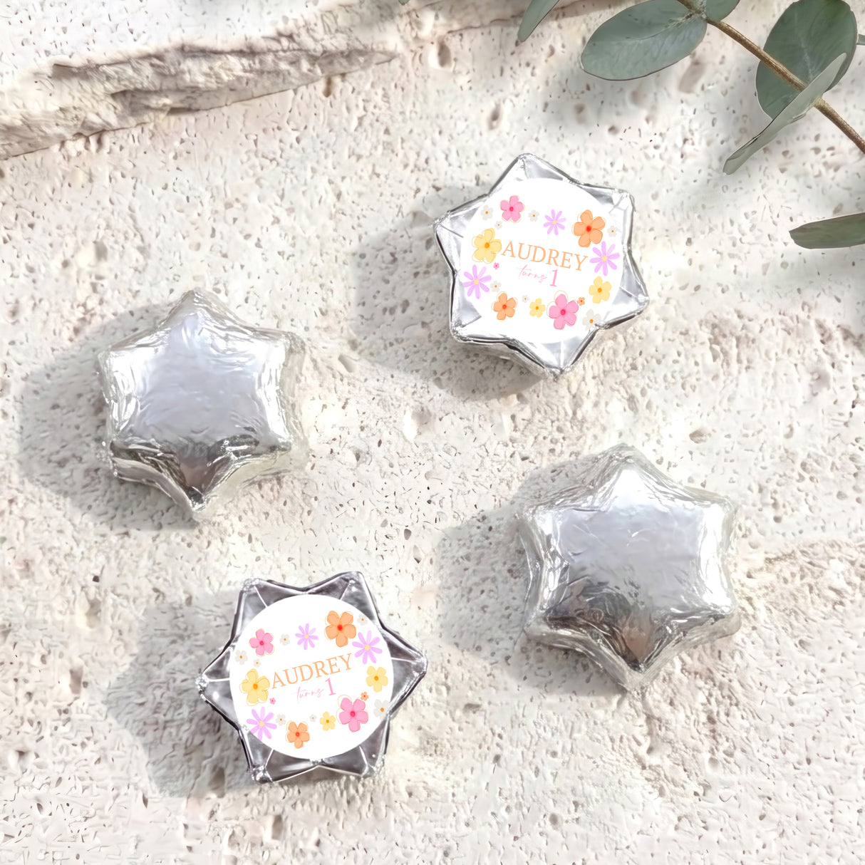 Personalised foil-covered chocolate stars in silver with flower label for Audrey