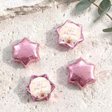 Foil-covered chocolate stars with pink metallic wrap and floral thank-you label