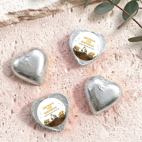 Foil-covered chocolate hearts in silver foil with birthday label featuring a construction truck