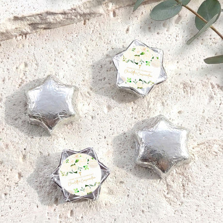 Foil-covered chocolate stars in silver tone with floral confirmation label