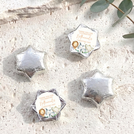 Foil-covered chocolate stars with white thank-you card and watercolor baby animals detail