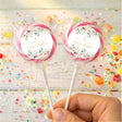 Pink and cream floral christening personalised lollipops on clear-wrapped sticks