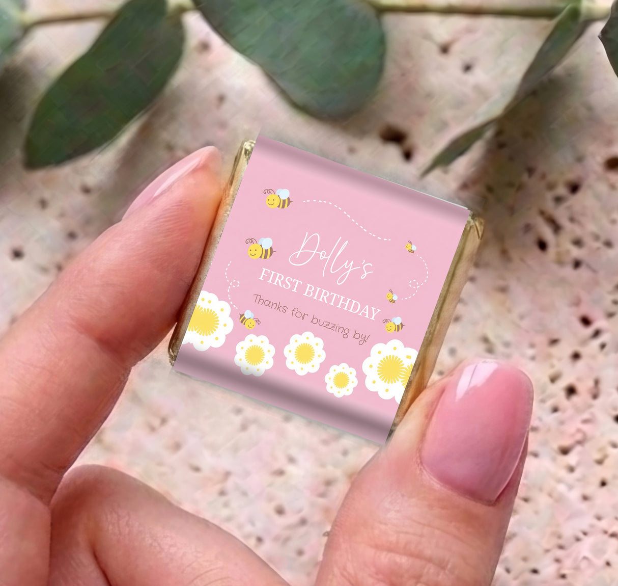 Pink mini chocolate box with bee and flowers, “Dolly’s First Birthday” text on front