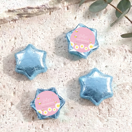 Blue foil-covered chocolate star with “Dolly’s First Birthday” bee label on front